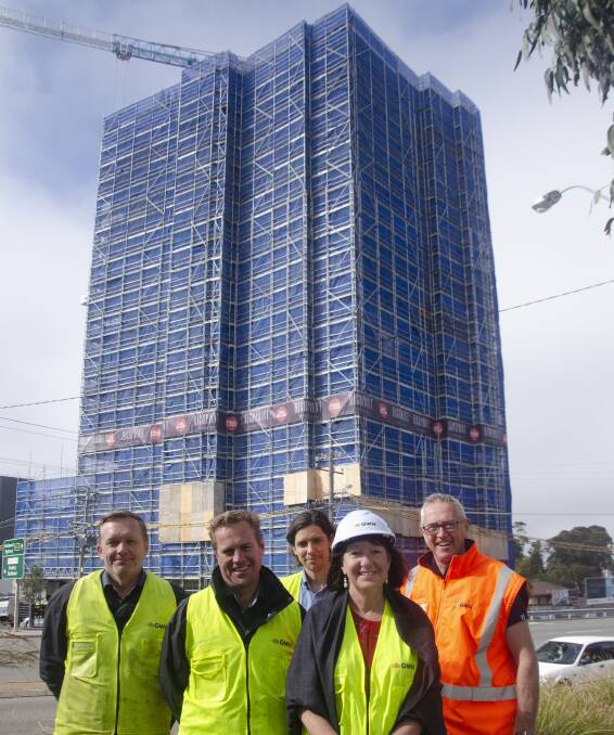 TALL ORDER: Lake Macquarie mayor Kay Fraser with team members from GWH in front of Charlestown apartment development Highpoint.