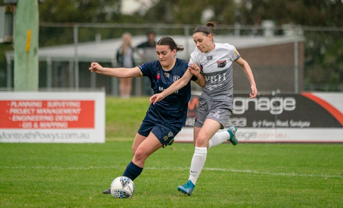 TIGHT TUSSLE: New Lambton's Taylah Bryde, left, and Warners Bay centre-back Kristy Martin vie for the ball at Arthur Edden Oval on Saturday. Picture: Mathew Packer