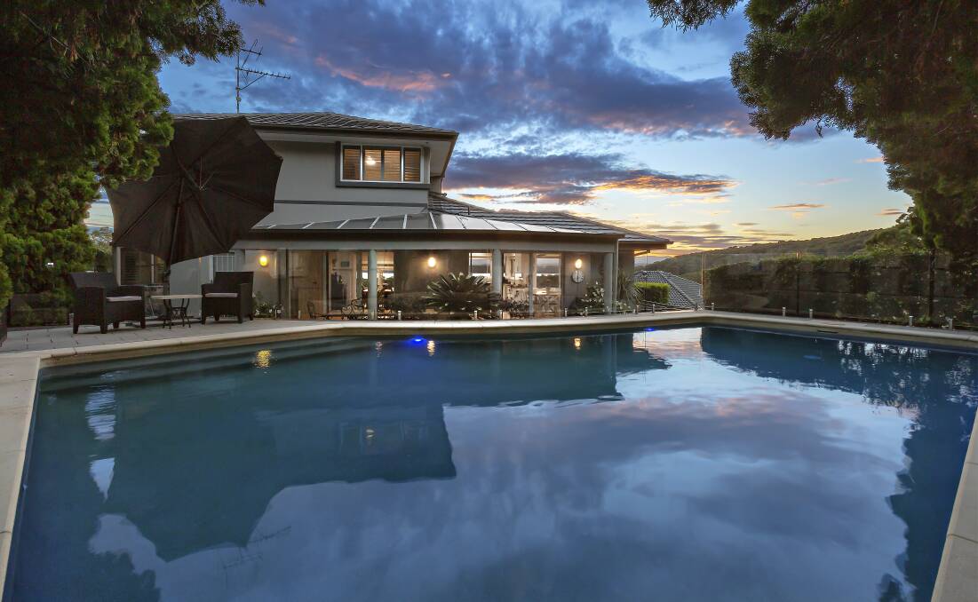 LAKE VIEWS: This two-storey residence at 2 Majella Close in Eleebana goes under the hammer today.