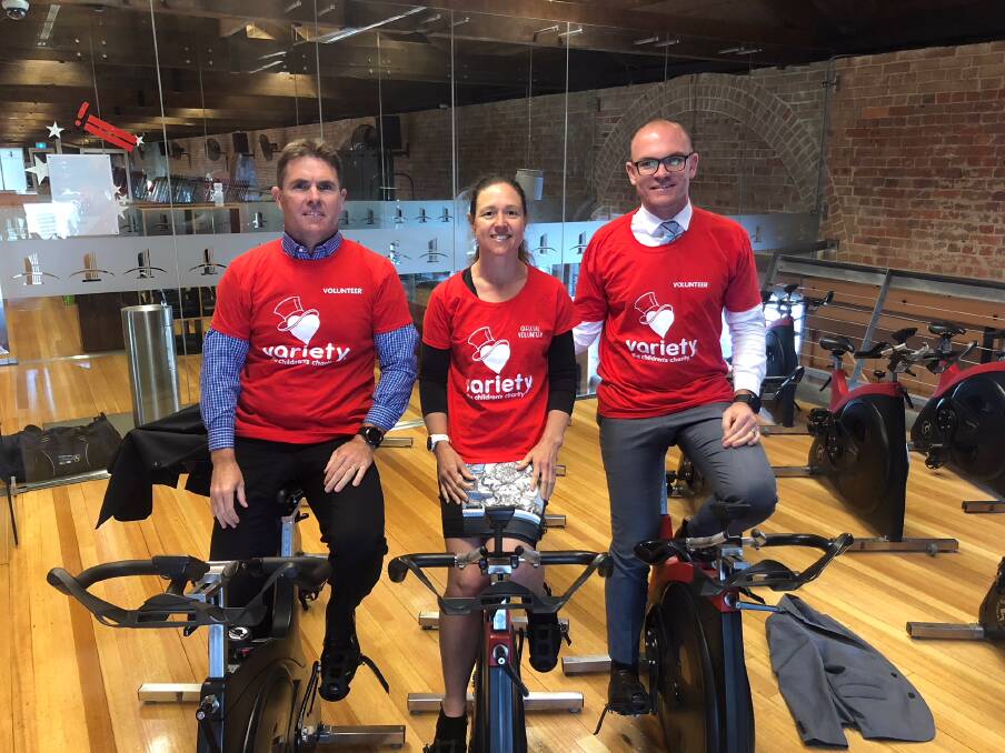 WORKPLACE CHALLENGE: Lambourne Partners partner Paul Franks, left, will take on a group of six colleagues, including Sonia Fuller and Kurt Purkiss, in Variety Spin 4 Kids on Friday. Picture: Supplied
