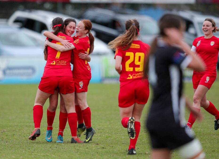 VICTORIOUS: Broadmeadow's Mel Price is swamped by teammates after scoring with a long-range effort in Magic's 3-1 win over Mid Coast in Herald Women's Premier League at Magic Park on Sunday. Picture: Max Mason-Hubers