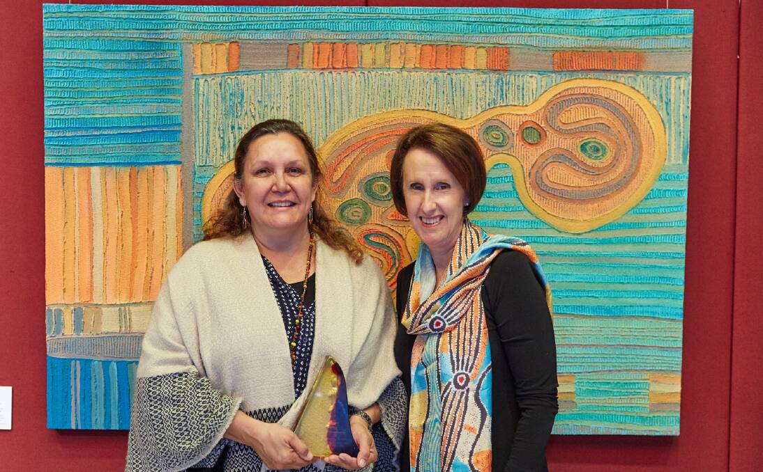 MAJOR AWARD: Toronto artist Saretta Fielding, left, and NSW Minister for Indigenous Affairs Leslie Williams with her winning piece Konara Clan. The win continues a run of success for the artist. Picture: Supplied