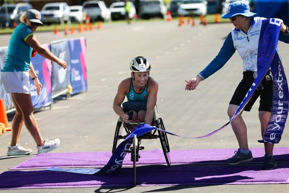 Lauren Parker was all smiles as she crossed the finish line to secure another Oceania Paratriathlon crown at Stockton on Sunday. Picture by Jonathan Carroll