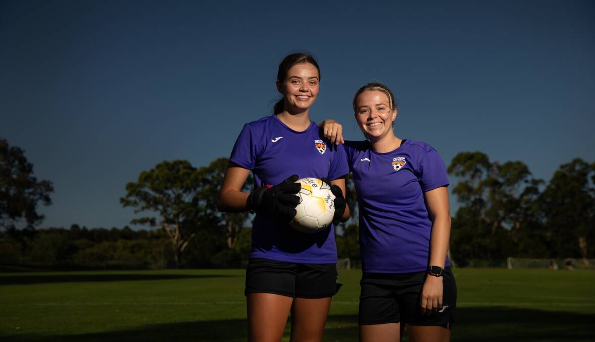 Ruby Jones, left, pictured with sister Ellie after bravely returning to the field last year following a horrific head injury. Picture by Marina Neil