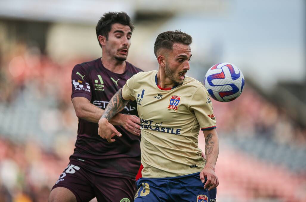 Jets midfielder Reno Piscopo, right, hit the woodwork with a free kick as Newcastle chased the game at McDonald Jones Stadium on Saturday. Pictures by Marina Neil