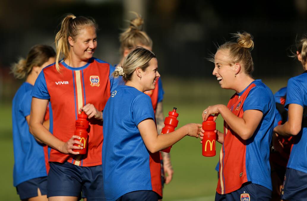CORE GROUP: Newcastle's all-time leading scorer Tara Andrews, left, looks on as Cassidy Davis and Hannah Brewer share a laugh at Jets training during the week. Picture: Jonathan Carroll