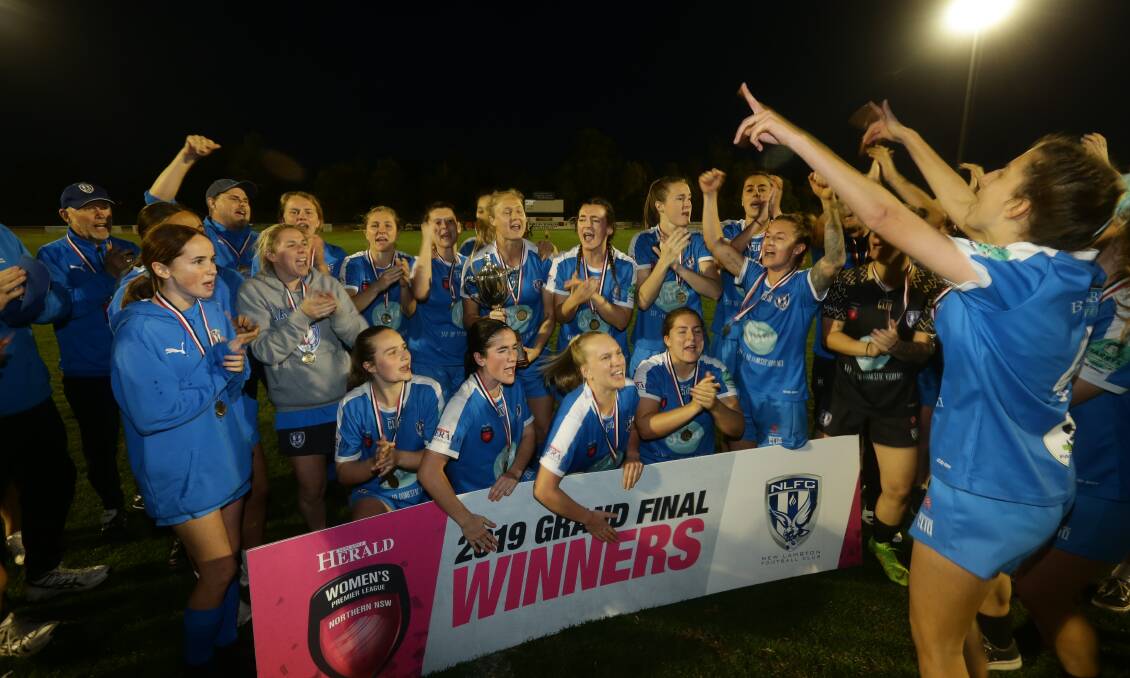 Keelan Hamilton, second from left back, celebrates New Lambton's grand final win over Merewether in Herald Women's Premier League this season. Picture: Jonathan Carroll
