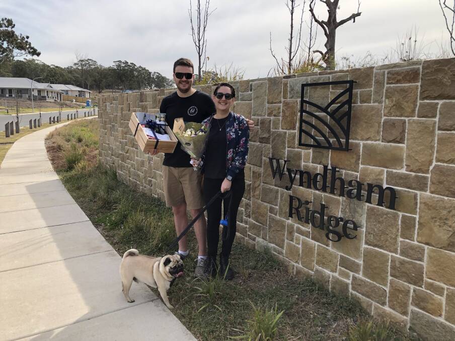 HAPPY: James Ferguson and Casey Noud, pictured with their dog Hugo, have bought in Wyndham Ridge.