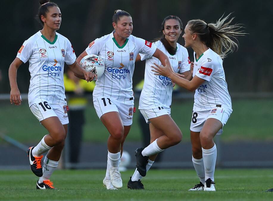 BREAKTHROUGH: Rhianna Pollicina is congratulated by Jets teammates after scoring at Latrobe City Stadium on Sunday. Picture: Getty Images