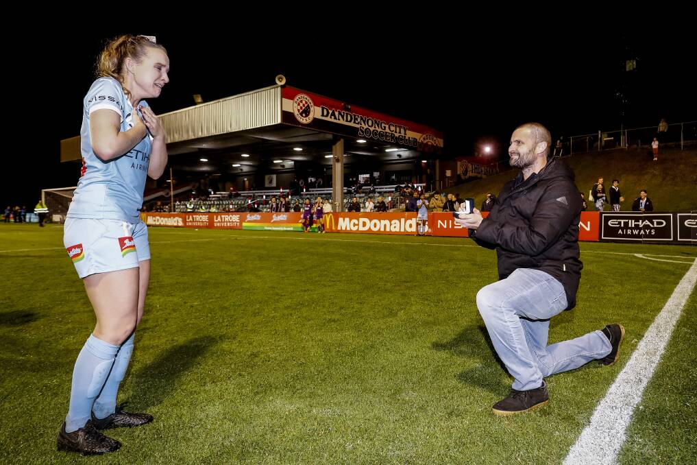East Maitland's Matt Stonham proposes to Rhali Dobson at her final W-League appearance at Frank Holohan Reserve on Thursday night. Picture: Getty Images