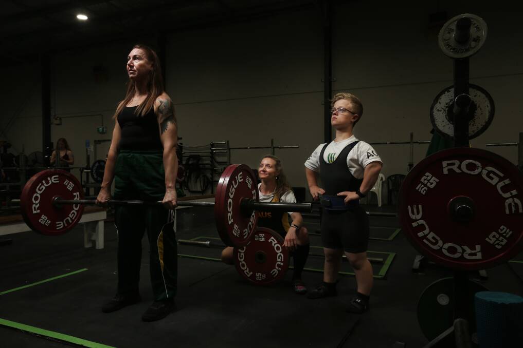 Powerlifters, from left, Melanie Green doing a warm-up deadlift, Natalie Bartolo and Luke Talley at Hunter Performance Centre. Picture by Simone De Peak