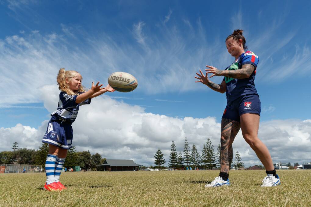 HAVING A GO: NRLW Knights player Jayme Fressard, pictured throwing the ball with five-year-old Kyah Day-Ridley, is excited to be part of Girls Day Out at Empire Park on Saturday. Picture: Max Mason-Hubers