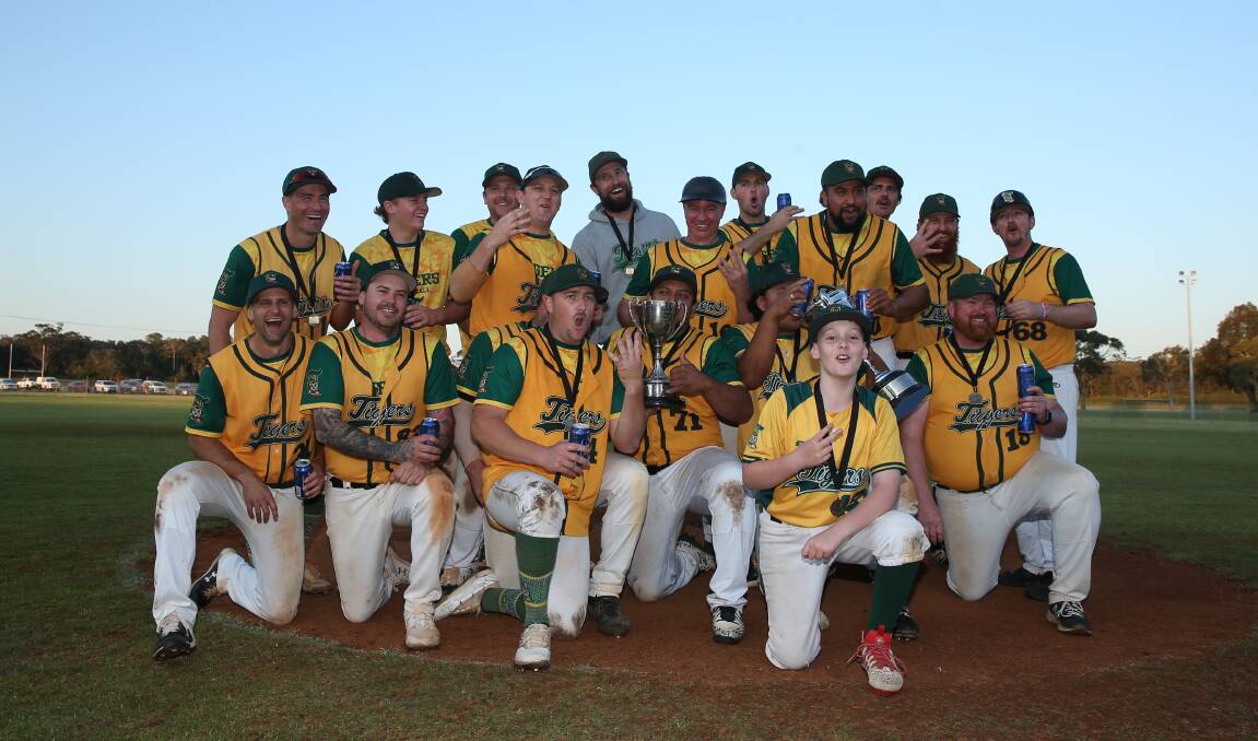 Toronto Tigers celebrate after capturing their fourth straight first-grade premiership in Newcastle Baseball at Belmont's Miller Field on Sunday. Picture by Marina Neil