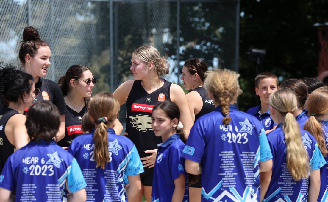 Lara McSpadden, left, and her Sydney Flames teammates kicked off a three-day promotional tour to the region with a clinic at Charlestown South Public School on Friday. Picture by Peter Lorimer