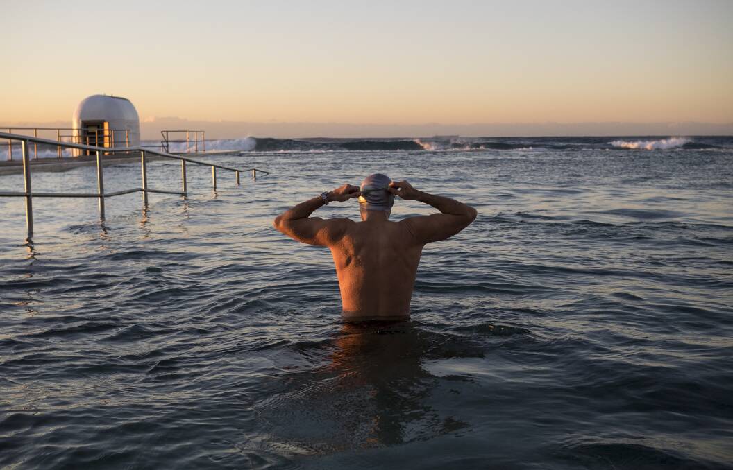 GOGGLES ON: Brydie Piaf has captured scenes of sunrise swimmers at Merewether Ocean Baths. This is one of the images which forms part of her exhibition on at Newcastle Region Library. Picture: Brydie Piaf