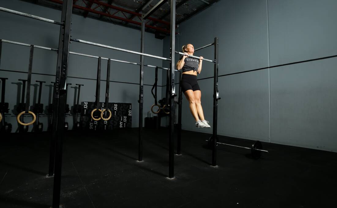 Nerida Bint, trainer and owner of Lissome gyms in Newcastle and Maitland, demonstrates a pull-up. Picture: Jonathan Carroll