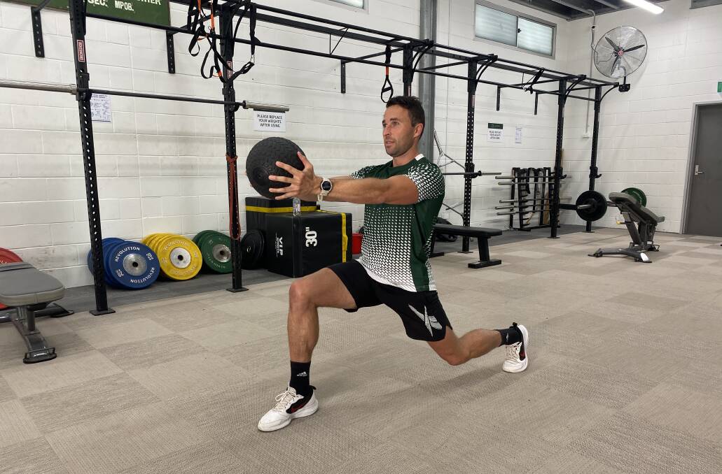 Scott Hingston, a personal trainer who operates out of Green Life Gym in Merewether, demonstrates a lunge with medicine ball. Picture: Supplied