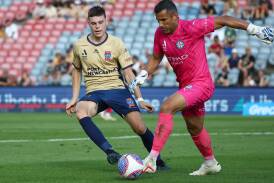Newcastle Jets rookie Justin Vidic, in his A-League debut, puts pressure on Melbourne City goalkeeper Jamie Young. Picture Getty Images
