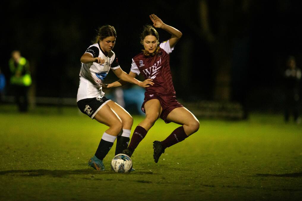 BATTLE: Maitland's Mercedes McNab, left and Warners Bay's Georgia Cook vie for the ball in NPLW Northern NSW at John Street Oval on Saturday night. Picture: Marina Neil