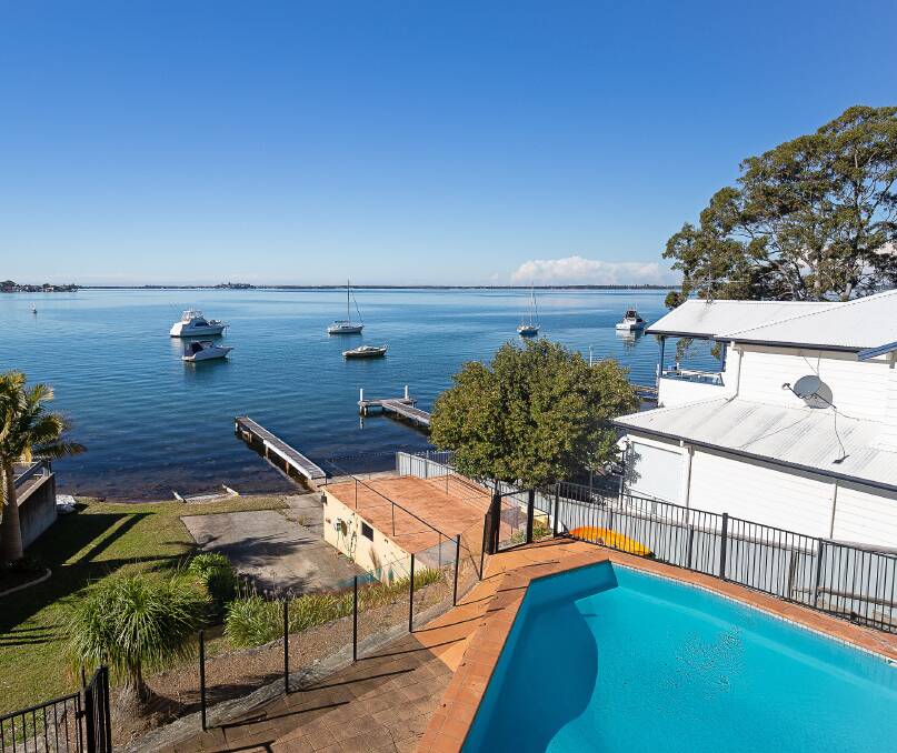 ABSOLUTE WATERFRONT: This home in Fishing Point is set for auction on August 23.