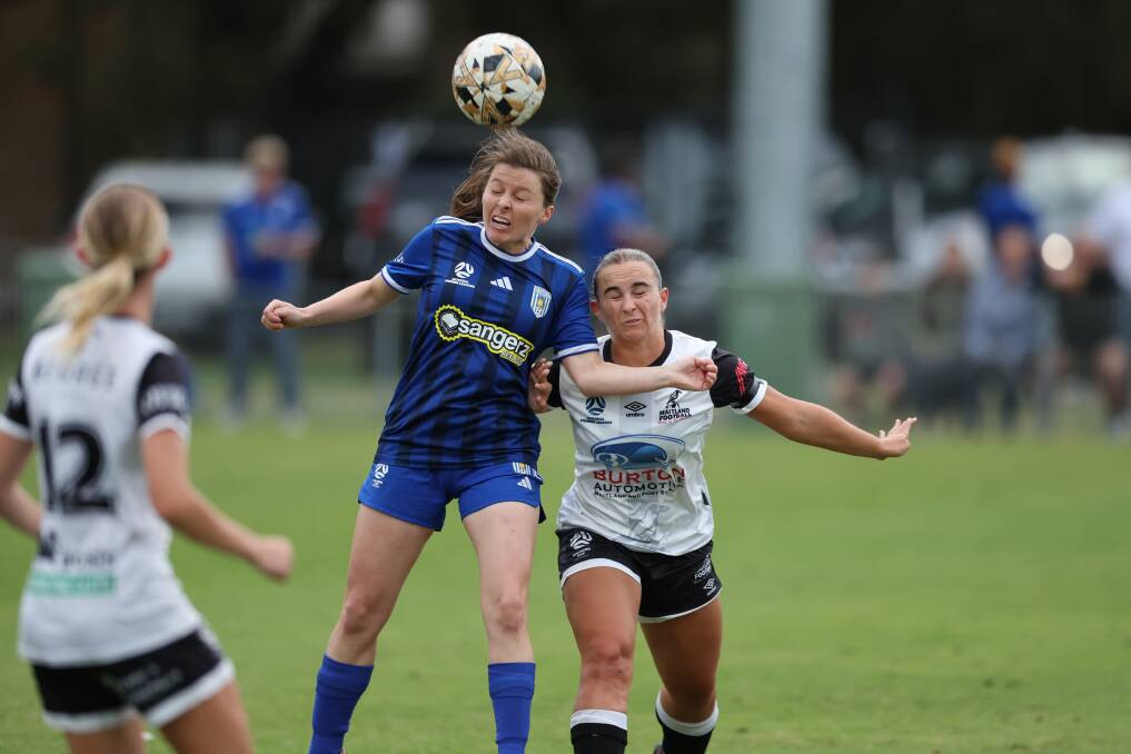 Newcastle Olympic's Elodie Dagg and Maitland's Paige Kingston-Hogg vie for the ball at Darling Street Oval on Saturday. Picture by Sproule Sports Focus