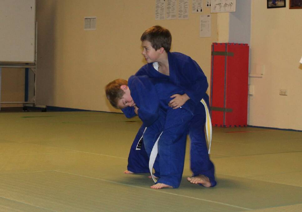 HOLDING ON: Lake Macquarie PCYC judo students Bailey Sawyer and Locke Sawyer.