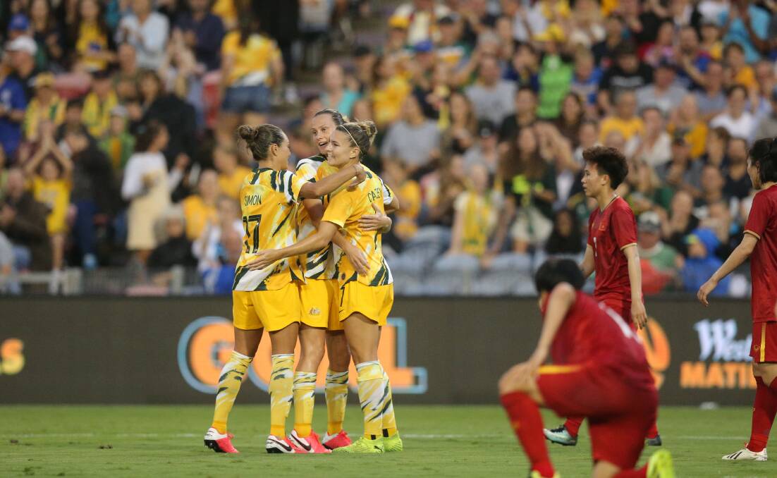 Matildas Kyah Simon and Steph Catley congratulate Emily van Egmond on her goal in a 5-0 win over Vietnam at McDonald Jones Stadium in March 2020. Picture: Max Mason-Hubers