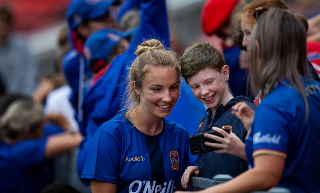 Jets midfielder Alisha Bass gets a selfie with a fan when Newcastle's 2020-21 W-League squad was unveiled at McDonald Jones Stadium in December. Picture: Marina Neil