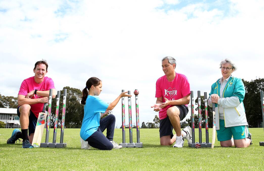 ENGAGED: From left, University of Newcastle Professor Phil Morgan, nine-year-old Ellie with dad Gary Johnstone and Cricket Australia's Jane Moffat at a Dads and Daughters Cricket program clinic. Picture: Peter Lorimer