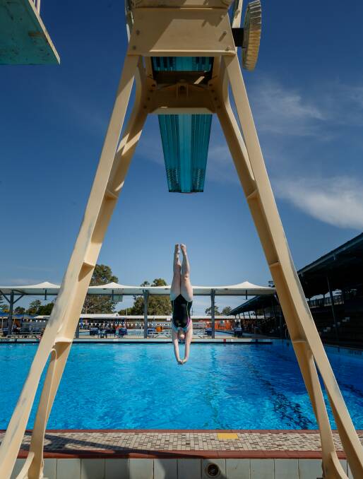TAKING THE PLUNGE: A diver practises at Lambton Pool. Picture: Max Mason-Hubers