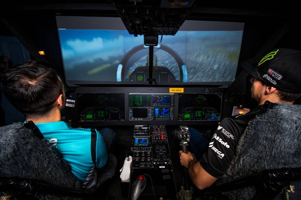 IN CONTROL: Michael Caruso and Cameron Waters in a flight simulator at the Westpac Rescue Helicopter Service base at Broadmeadow, Newcastle. Picture: Simon McCarthy. 
