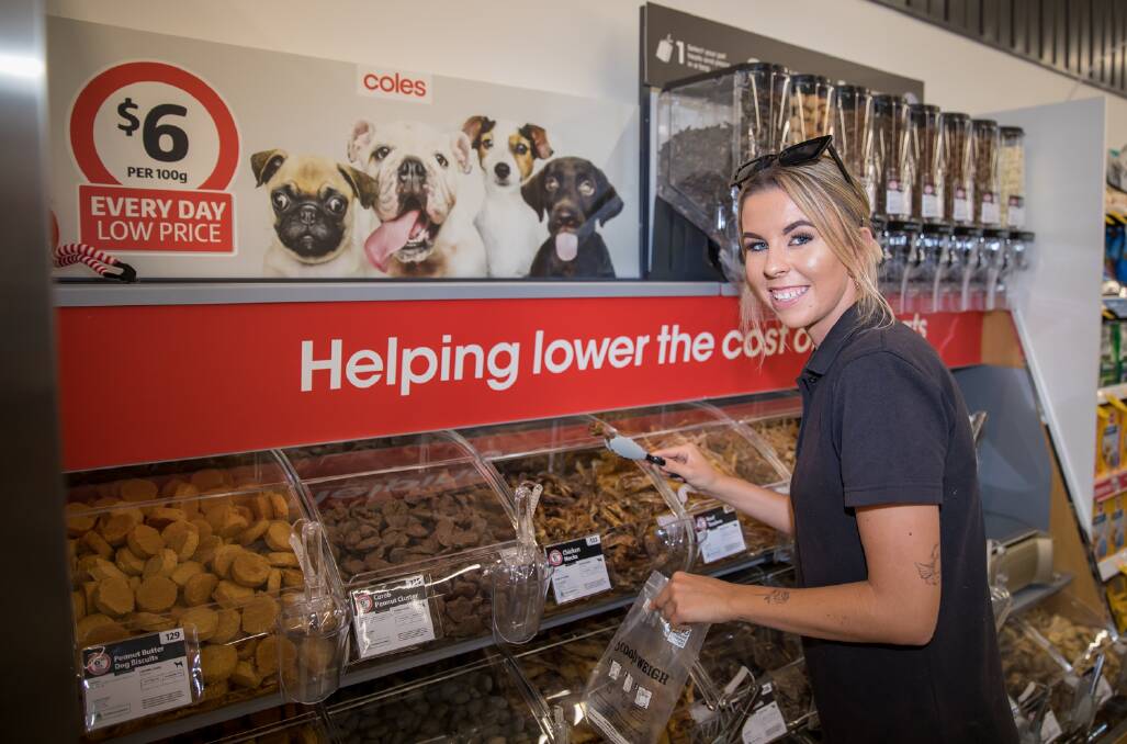 POPULAR: A shopper takes a selection from the pick-and-mix dog treats bar. 