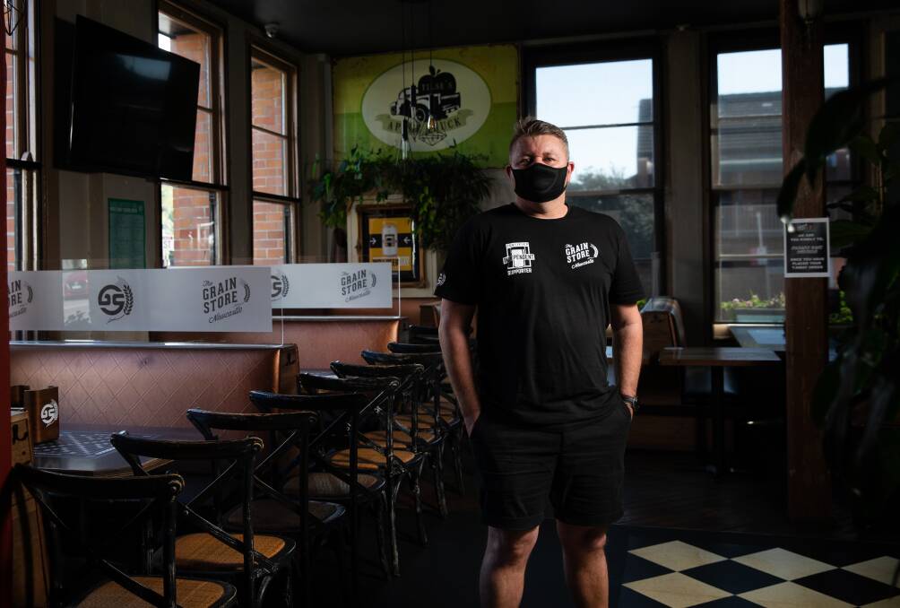 EMPTY FEELING: Corey Crooks inside his Newcastle East bar and restaurant Grain Store on Thursday. Mr Crooks encouraged Hunter residents to strictly adhere to the public health orders over the next week to give the region the best possible chance of exiting lockdown. Picture: Marina Neil