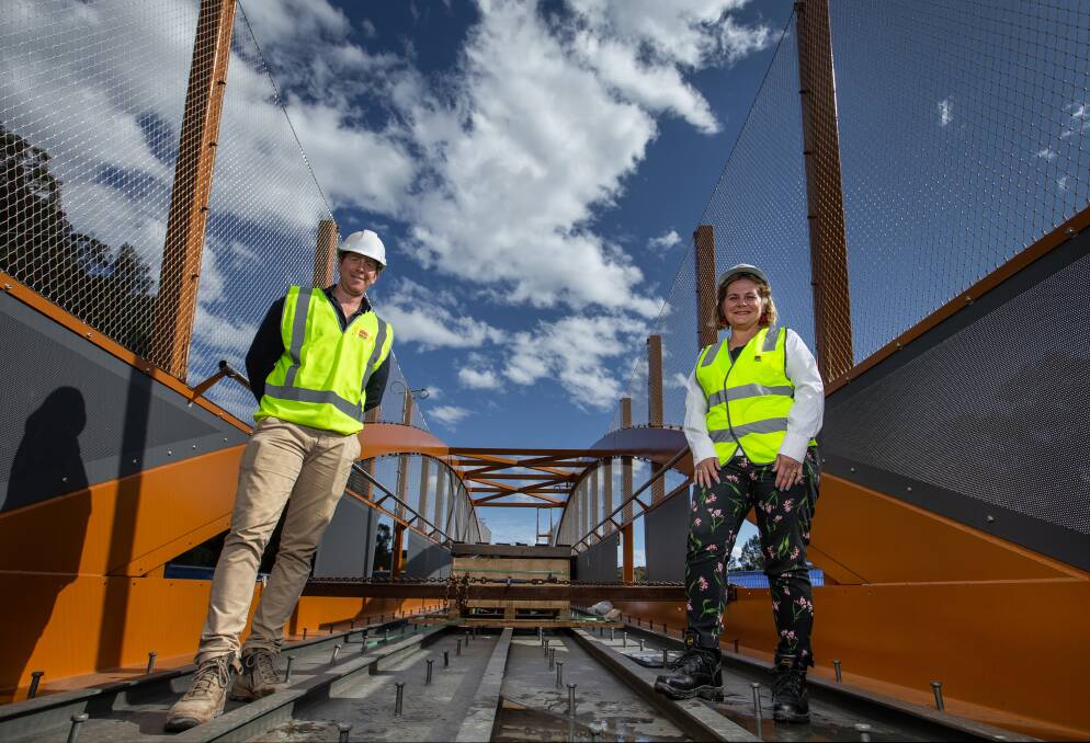 BIG LIFT: Project officer Michael Edwards with Transport for NSW regional director Anna Zycki standing on the bridge span in Jesmond on Friday. Picture: Marina Neil
