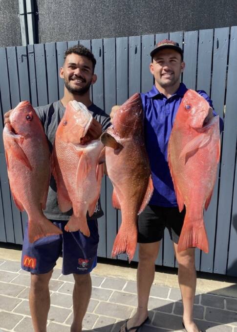 BIG CATCH: Knights hooker Chris Randall, right, with NSW Cup player McKenzie Baker. Picture: Instagram 