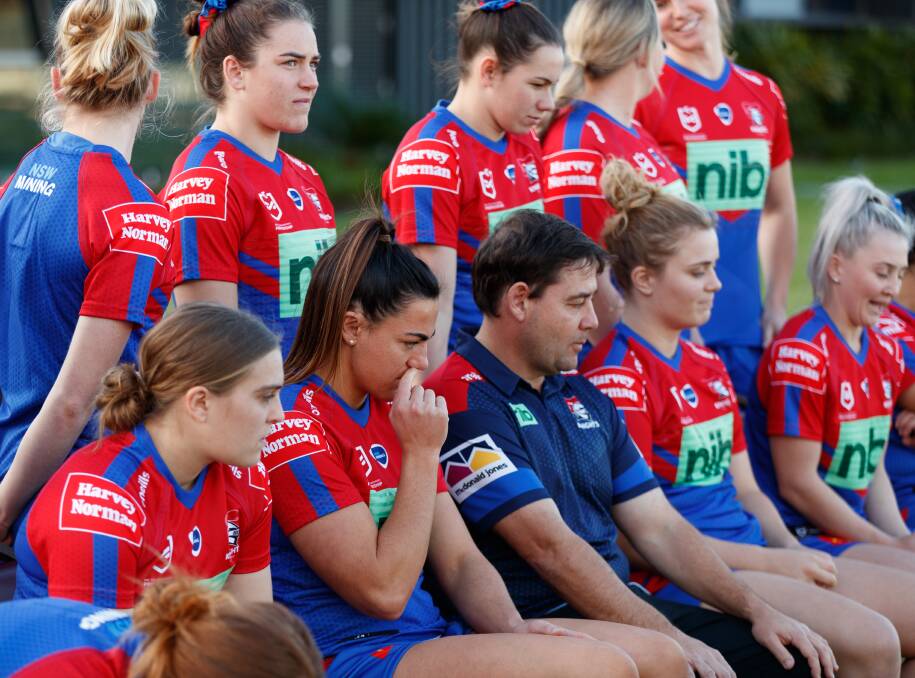 BIG LOSS: Newcastle Knights coach Ron Griffiths, centre, alongside co-captains Hannah Southwell, right, and Millie Boyle, left, during the team-photo shoot. Southwell will miss the rest of the season. Picture: Max Mason-Hubers
