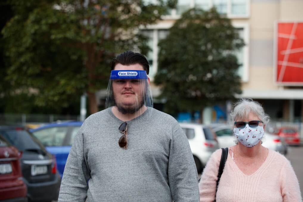 PROTECTION: A man wearing a face shield and woman wearing a face mask outside Marketown in Newcastle West on Tuesday. The NSW Premier has called for more people to use masks. Picture: Max Mason-Hubers