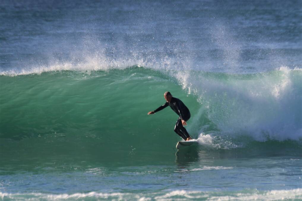 SMOOTH RIDE: A surfer at Merewether on the weekend. Picture: Dave Anderson