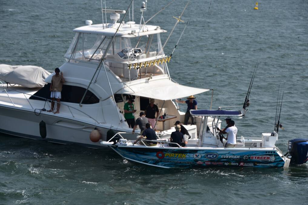 WELCOME ABOARD: Race fans transferring boats. 