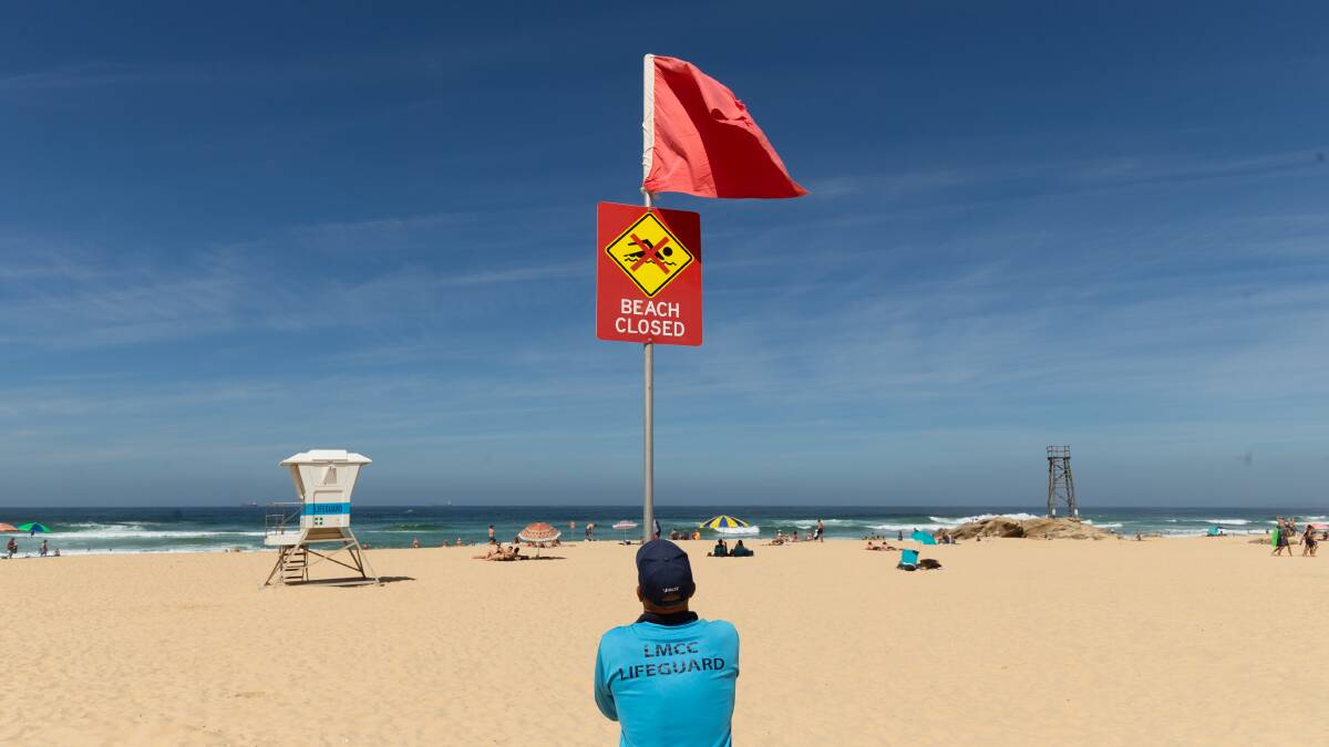 CLOSED: A lifeguard at Redhead beach. Picture: Max Mason-Hubers