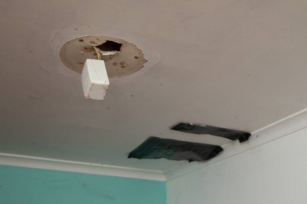 DAMAGE: A fitting hanging from the ceiling and two holes covered with plastic. 