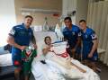 Knights players Dylan Lucas, Jacob Saifiti and Jayden Brailey with Savannah Bamblett, who suffered a broken leg during a recent footy match, at John Hunter Children's Hospital on Tuesday. Picture by Marina Neil