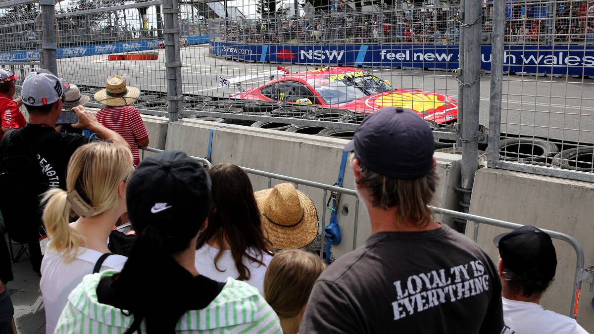 Race fans watch the action at turn one near Customs House on Friday. Picture by Peter Lorimer