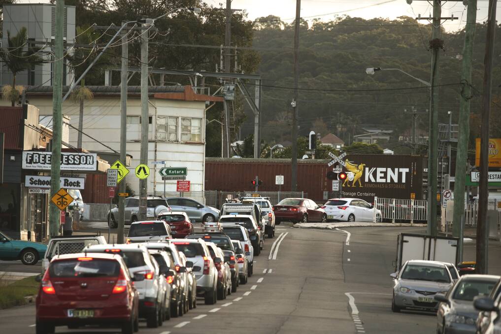 HEADACHE: Traffic backed up on Glebe Road at the Adamstown railway crossing as a freight train passes by. A freight rail line between Fassifern and Hexham would reduce the amount of time the boom gates are down. Picture: Marina Neil