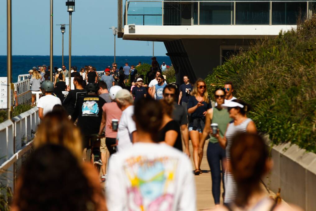 OUT AND ABOUT: Part of the long stretch of people traversing Bathers Way near Merewether Surfhouse on Sunday. Picture: Jonathan Carroll 