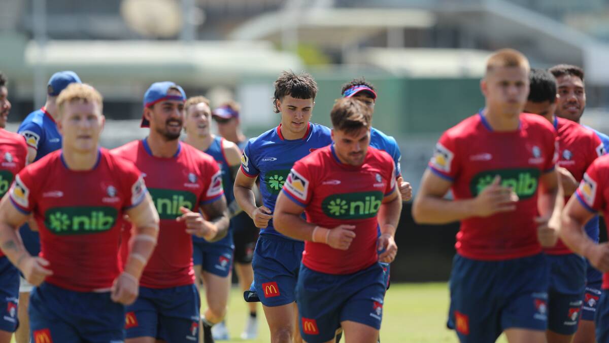 Ryan Rivett, pictured centre in the blue top, will make his NRL debut for the Knights against the Dolphins tonight. Picture by Max Mason-Hubers 