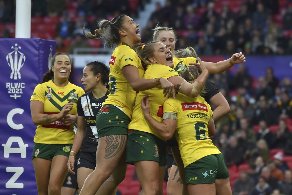 Caitlan Johnston, centre, celebrates with her Australia teammates during the World Cup final in England on Sunday. 