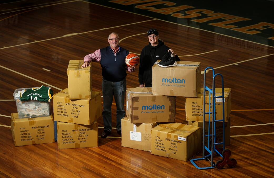 DONATIONS: Newcastle Basketball board member and Awabakal Land Council CEO Rob Russell and Chloe Mullaney with the boxed gear on Friday. Picture: Marina Neil