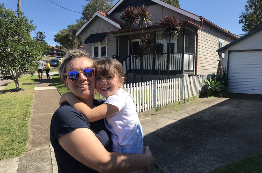 YEAR-LONG SEARCH: Jo Cunningham and one of her daughters in front of the Waratah house they viewed. 