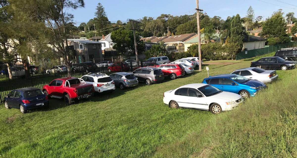 DONE: Cars parked on the grass reserve at the end of Mary Street on Tuesday, where commuters were being fined. The spot is a 200m walk from Cardiff train station. 